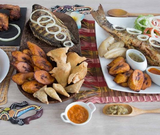 Kamerun, Afrika’nın en zengin mutfak kültürlerinden birine sahiptir. Ülkenin coğrafi yapısı, tropikal iklimi ve çok sayıda etnik grubun bir arada yaşaması, Kamerun mutfağı için son derece geniş bir çeşitlilik sunar. Farklı bölgelerde yaşayan toplulukların yemek alışkanlıkları birbirinden farklıdır. Bu farklılıklar, ülkenin kuzeyinden güneyine, batısından doğusuna kadar sofralara yansıyan çok renkli bir gastronomi tablosu ortaya çıkarır. Baharatların bolca kullanılması, taze sebze ve kök bitkilerin yemeklerde sıkça yer alması Kamerun sofralarının karakteristik özelliklerinden biridir. Konulu bir haber görseli.